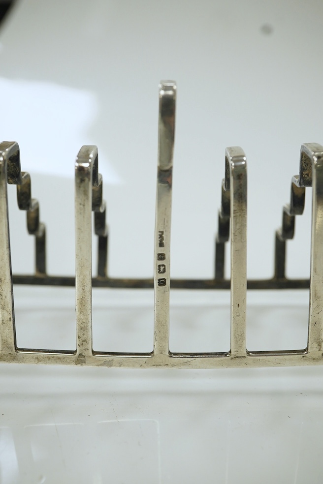 An unusual George V stepped silver seven bar toast rack, by A L Davenport Ltd, Birmingham, 1938, length 13.4cm. Condition - fair